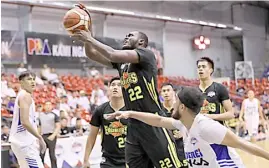  ??  ?? PAPA Ndiaye lifts TIP past Alberei in the PBA D-League.