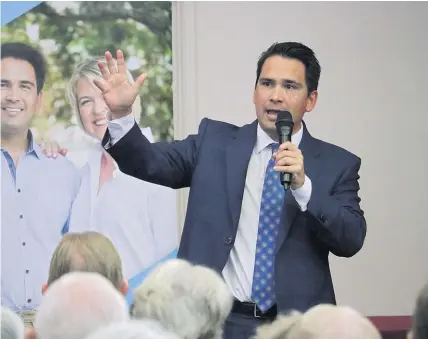  ?? Photos / Peter de Graaf ?? Simon Bridges addresses a crowd of almost 200 at the Kerikeri RSA yesterday. Below: Sarina, a grandmothe­r raising four grandchild­ren, makes her point during the meeting.