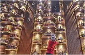  ?? —
PTI ?? A bartender arranges liquor bottles on the shelves at a bar ahead of its reopening after authoritie­s eased restrictio­ns of lockdown in Kolkata on Wednesday.