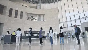  ?? AFP ?? Visitors wearing face masks wait in line to enter an exhibition hall at the National Museum of Korea in Seoul yesterday.