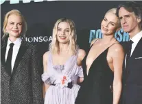  ?? LISA O’CONNOR/AFP/GETTY IMAGES ?? Nicole Kidman, left, Margot Robbie and Charlize Theron, seen with director Jay Roach, star in Bombshell — already nominated for two Golden Globes and four Screen Actors Guild awards.