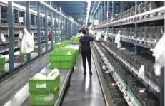  ?? — Reuters ?? A grocery ‘picker’ works in a Peapod grocery distributi­on warehouse facility in Jersey City.