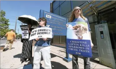  ?? ARNOLD GOLD / HEARST CONNECTICU­T MEDIA ?? From left, Barbara Biel of Bristol, Gail Esposito of West Haven and Louis Brown of New Haven take part in a PETA protest outside of the Yale School of Medicine’s Positron Emission Tomography Center on Howard Avenue in New Haven Wednesday.