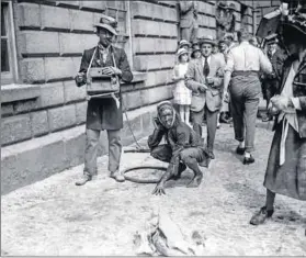  ?? Press Agency/Getty Images Photo: Walshe/Topical ?? Grinding on: Students at the University of Dublin in June 1922 took to the city’s streets during Trinity College Rag Week.