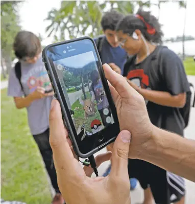  ?? ALAN DIAZ/ASSOCIATED PRESS ARCHIVES ?? Many people are still head over heels for “Pokémon Go,” but the buzz has died down. Last week, the game ended its reign as the top-grossing U.S. iPhone app after 74 days on top, replaced by “Clash Royale.”