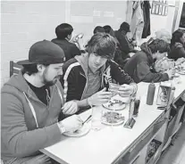  ??  ?? Scozzari, left and Mike Bollar eat at Lafayette Coney Island in Detroit last month. About 140 Coney Islands are listed in Detroit, many are family-style restaurant­s compared to 72 McDonald’s, Burger King, Wendy’s and KFC franchises in Detroit.