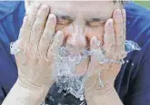  ?? RICK BOWMER, AP ?? Terri Patterson cools off at a fountain in Salt Lake City.