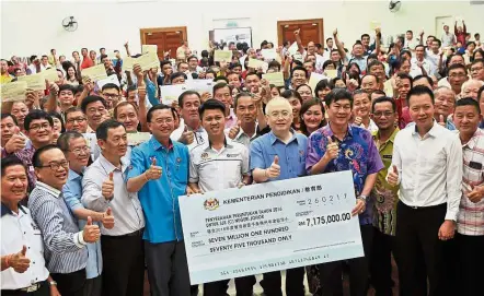  ??  ?? Financial boost: Chong (centre, in white shirt), Dr Wee (on Chong’s left), Johor MCA liaison committee deputy chairman Datuk Tee Siew Kiong (on Chong’s right) and school headmaster­s and board of directors giving the thumbs up after receiving the...