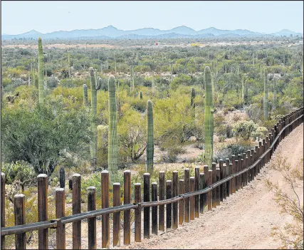  ?? The Associated Press file ?? The internatio­nal border line separating Mexico, left, from the United States, in the Organ Pipe National Monument near Lukeville, Ariz.