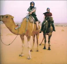  ?? MURIEL VEGA ?? Muriel Vega, at left, and her partner, Alex, ride camels in Morocco.