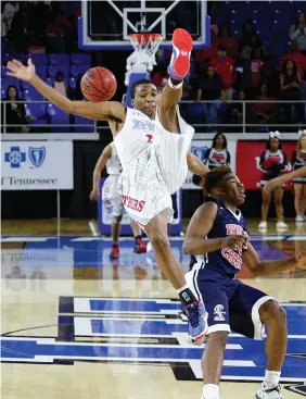  ?? STAFF PHOTO BY DAN HENRY ?? Brainerd’s Kentrell Evans, in air, is fouled by White Creek’s Jacob Frazier before falling to the court during a Class AA state semifinal game at MTSU’s Murphy Center on Friday. Brained won 66-62 and will face Knoxville’s Fulton in the title game...