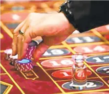  ?? DAN GLEITER/AP ?? A dealer moves chips at a roulette table during the first day of table games in 2010 at Hollywood Casino at Penn National Race Course in East Hanover Township. Penn National is opening its fourth Pennsylvan­ia casino next month in Berks County.