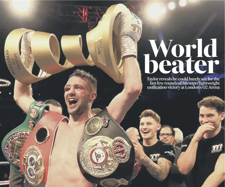  ?? Neil Mcglade reports from London, ?? 0 A jubilant Josh Taylor raises the Muhammad Ali Trophy aloft late on Saturday night following his thrilling points victory against Regis Prograis.