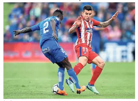  ??  ?? Out of my way: Atletico Madrid forward Correa (right) vying for the ball with Getafe defender Djene during the La Liga match at the Coliseum Alfonso Perez Stadium on Saturday. — AFP