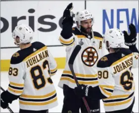  ?? SCOTT KANE — THE ASSOCIATED PRESS ?? Boston Bruins center Patrice Bergeron (37) celebrates with Marcus Johansson (90), of Sweden, and Karson Kuhlman (83) after the Bruins beat the St. Louis Blues in Game 6 of the NHL hockey Stanley Cup Final Sunday in St. Louis. The Bruins won 5-1 to even the series 3-3.