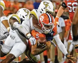  ?? JOHN BAZEMORE/AP ?? Clemson QB DJ Uiagalelei (5) fumbles as he is hit by the Jackets last week. Tech used a new defensive look, which helped limit the Tigers to 284 total yards.