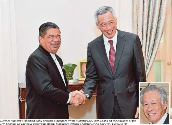  ?? BERNAMA PIX ?? Defence Minister Mohamad Sabu greeting Singapore Prime Minister Lee Hsien Loong on the sidelines of the 17th Shangri-La Dialogue yesterday. (Inset) Singapore Defence Minister Dr Ng Eng Hen.