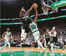  ?? CHARLES KRUPA/AP ?? Milwaukee Bucks guard Jrue Holiday (21) blocks a shot by Boston Celtics guard Marcus Smart (36) in the final seconds of Game 5 of their Eastern Conference semifinal on Wednesday. The Bucks won 110-107 to take a 3-2 series lead back to Milwaukee.