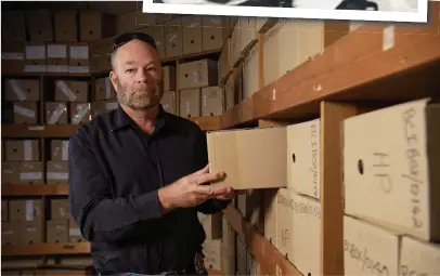  ??  ?? Detective Senior Sergeant Mark Stringer looks over old cases as he prepares to retire after 33 and a half years in the NT Police Force