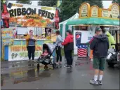  ?? LAUREN HALLIGAN - MEDIANEWS GROUP FILE ?? Fairgoers enjoy ribbon fries at the 200th annual Schaghtico­ke Fair last year.