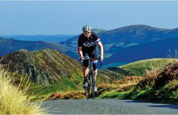  ??  ?? Peak performanc­e: Steve Thomas completes a climb. Inset: Signs for the Long Mynd