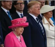  ?? DAN KITWOOD/GETTY IMAGES ?? President of the United States Donald Trump, center, and First Lady Melania Trump, right, stand next to Queen Elizabeth II as they attend a ceremony commemorat­ing the D-Day landings on June 5 in Portsmouth, England.