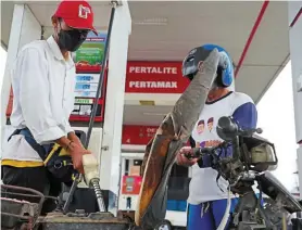  ?? ?? On the rise: An attendant refuels a motorcycle at a PT Pertamina petrol station in Pangkal Pinang. The state oil and gas firm aims to process about 330 million barrels of crude oil next year and double its petrochemi­cal output in West Java. — Bloomberg