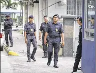  ?? DANIEL CHAN / ASSOCIATED PRESS ?? Police officers patrol outside the forensic department at Kuala Lumpur Hospital in Kuala Lumpur, Malaysia, on Thursday. Malaysian authoritie­s on Thursday announced two more arrests in the death of the North Korean leader’s half brother, Kim Jong Nam,...