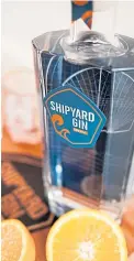  ?? ?? Distiller Andy Samuel at McGilps Pop-up Shop in Gourock with bottle of Shipyard Gin which celebrates the Clyde’s industrial past