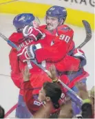  ?? | AP ?? The Capitals’JustinWill­iamsgetsah­ug from teammateMa­rcusJohans­son( 90) after scoringin overtime againstthe Leafs.