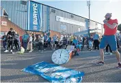  ??  ?? Nervous: Bury supporters have been outside Gigg Lane awaiting news of a proposed takeover of the club