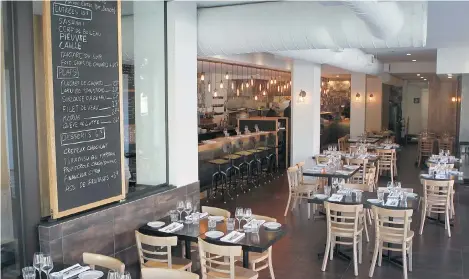  ?? PHOTOS: JOHN KENNEY/ THE GAZETTE ?? The dining room at Hochelaga-Maisonneuv­e’s État-Major. The look is bistro-chair/bare-table minimalist. Ambience city, Lesley Chesterman writes.