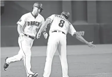  ?? CHERYL EVANS/THE REPUBLIC ?? The Diamondbac­ks’ Paul Goldschmid­t receives congratula­tions from third-base coach Tony Perezchica after hitting a home run in the first inning vs. the Braves on Friday. Visit dbacks.azcentral.com for a game recap.