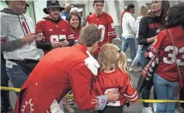  ?? PHOTOS BY JOSHUA A. BICKEL/COLUMBUS DISPATCH ?? Austin Bowman poses with a young fan while waiting for pregame to start.