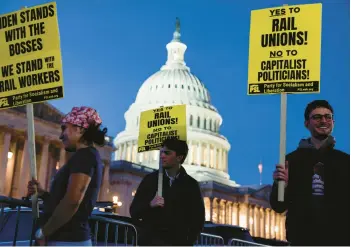  ?? ANNA MONEYMAKER/GETTY ?? Activists in support of unionized rail workers protest Tuesday outside the U.S. Capitol.