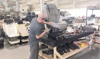  ?? — Reuters ?? An assembly line worker works on the production line at Midwest Automotive Designs in Bristol, Indiana, US.