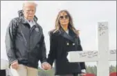  ?? AP ?? US President Donald Trump and first lady Melania Trump visit a line of crosses at Providence Baptist Church in Alabama.