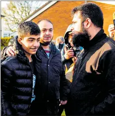  ?? Pictures: SWNS ?? Jamal greets supporters outside his school in Huddersfie­ld
