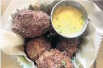  ?? LAUREN DELGADO/ORLANDO SENTINEL ?? Menagerie Eatery &amp; Bar's squash and bacon fritters are savory orbs of doughy goodness.