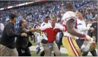  ?? RICK OSENTOSKI — THE ASSOCIATED PRESS FILE ?? In this photo, San Francisco 49ers head coach Jim Harbaugh, left, and Detroit Lions head coach Jim Schwartz, right, shout at each other after a game in Detroit.