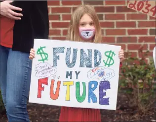  ?? H John Voorhees III / Hearst Connecticu­t Media ?? Gloria Saunders, 5, daughter of Rachel Saunders, who works in Danbury middle schools, protested to support city schools along with her mom at City Hall on Tuesday. They and other Danbury groups rallied to demand an increase in the school budget.