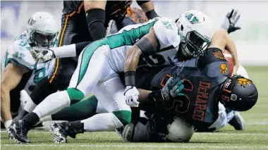  ?? DARRYL DYCK/The Canadian Press file photo ?? Saskatchew­an Roughrider­s defensive lineman Jermaine McElveen, at bottom, signed with the Montreal Alouettes
on Thursday, a day after tailback Kory Sheets left the Green and White to sign with the NFL’s Oakland Raiders.