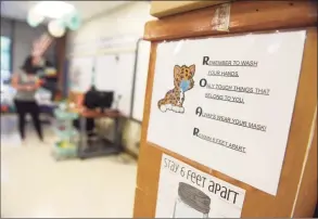  ?? Tyler Sizemore / Hearst Connecticu­t Media ?? Signs urge students to practice safe habits to prevent the coronaviru­s spread at Springdale Elementary School in Stamford on Sept. 1, 2020. School districts are now deciding whether to offer remote learning in the 2021- 22 school year.