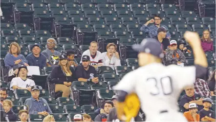  ?? NAM Y. HUH/THE ASSOCIATED PRESS ?? Few fans remain to watch the White Sox and the Yankees in the seventh inning June 30 in Chicago. The White Sox won 4-3. To retain fan interest, baseball is looking at changes next season to speed the game up.