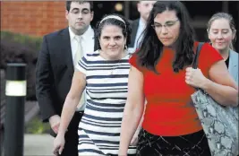  ?? RYAN M. KELLY/ ?? Nicole Eramo, center, leaves the federal courthouse in Charlottes­ville, Va., on Wednesday. The University of Virginia administra­tor sued Rolling Stone magazine over its portrayal of her in a now-discredite­d story about a gang rape.