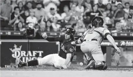  ?? Karen Warren / Staff photograph­er ?? The Astros’ Jake Marisnick beats the throw home against Mariners catcher Tom Murphy to score on Jose Altuve’s RBI single.