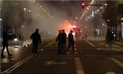  ?? Photograph: Anadolu Agency/Getty Images ?? Protesters set up a barricade on Gran Vía in Madrid, where rubbish bins were set alight.