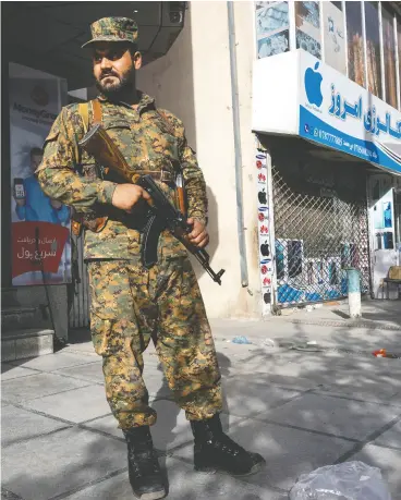  ?? PAULA BRONSTEIN / GETTY IMAGES ?? Kabul police secure areas in the central part of the city on Friday with tensions running high due to the Taliban advance.