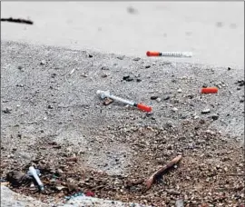  ??  ?? SYRINGES dot the banks of the Santa Ana River in November. Public health advocates say needle exchanges are crucial in preventing the spread of diseases.