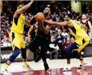  ?? AP PHOTO BY TONY DEJAK ?? Cleveland Cavaliers' Lebron James, center, drives between Indiana Pacers' Myles Turner, left, and Thaddeus Young during a playoff series Wednesday in Cleveland.